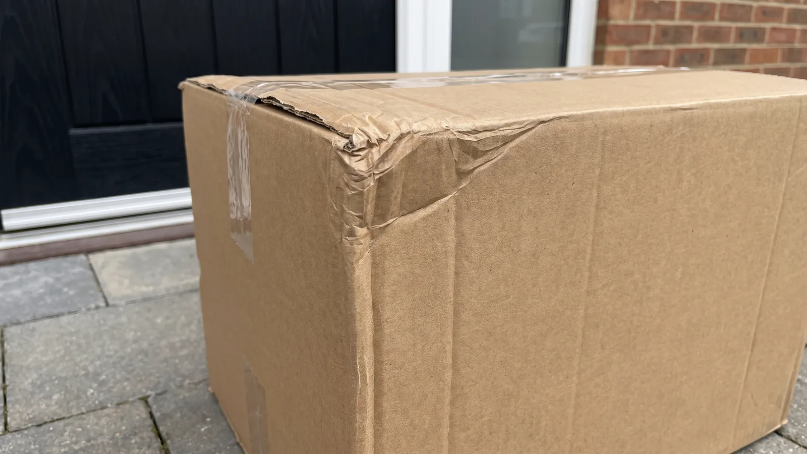 Visible external damage, a crushed corner and lifted tape, is the easier case: concealed damage arrives in a box that looks like this one does not.
